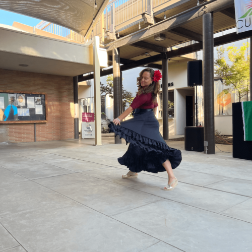 A woman twirls her skirt while dancing